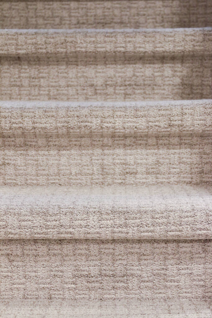 Finished Naperville basement remodel soft family-friendly stairway carpet.