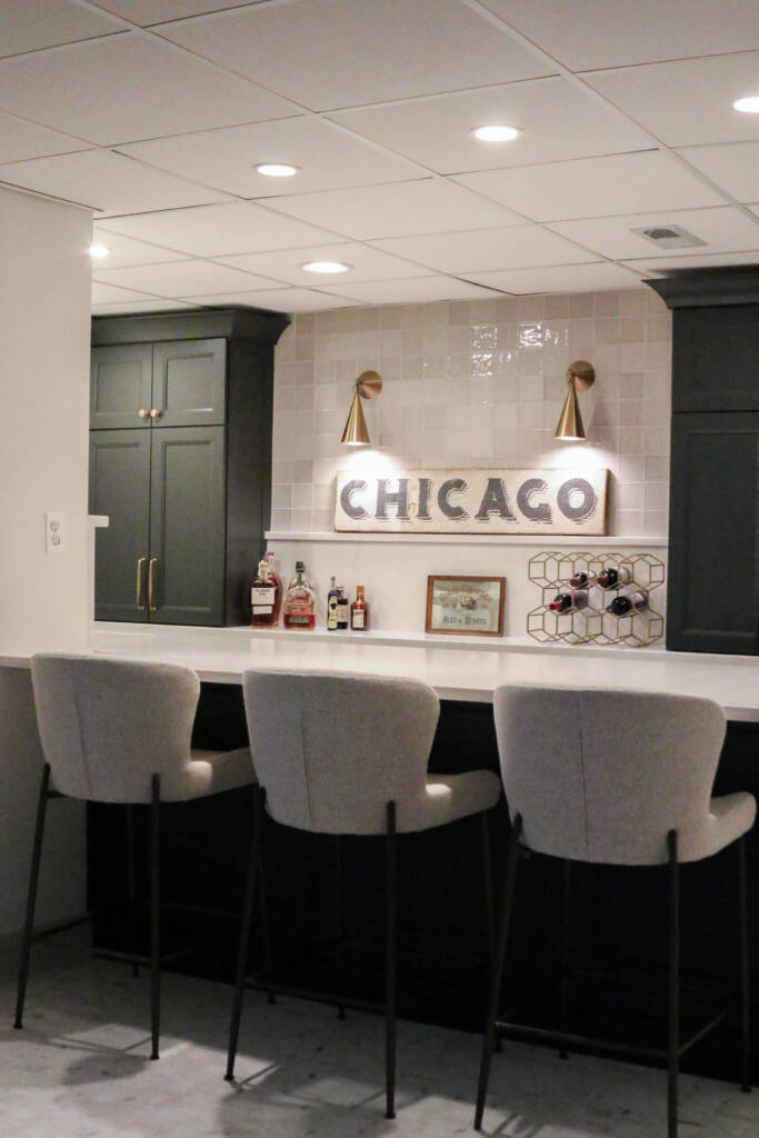 Finished basement remodel with custom bar seating, brass hardware, MSI Valentine countertop.