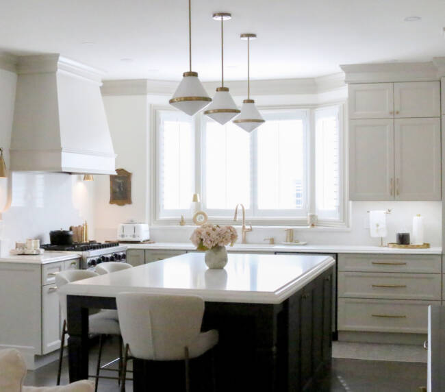 Completed kitchen remodel with custom cabinetry, MSI Valentine countertops, island seating, and refinished hardwood floors.