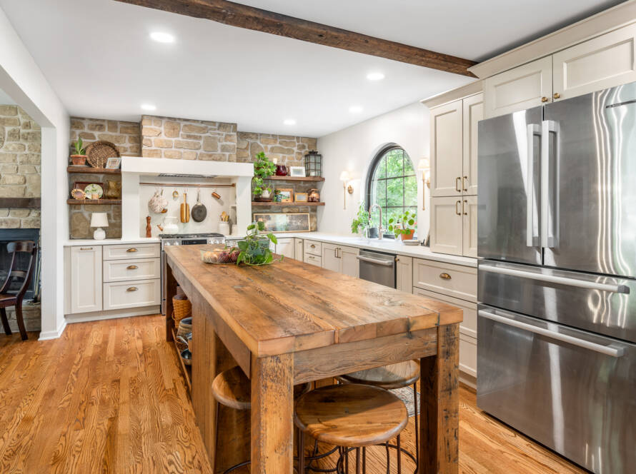Traditional kitchen remodel and expansion with arched window and reclaimed wood island.