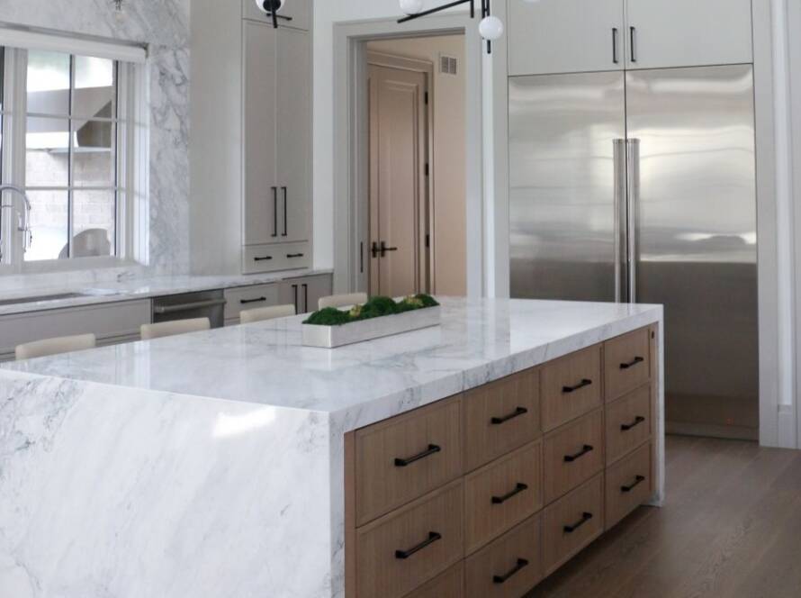 Luxury marble kitchen with high ceilings and waterfall marble island