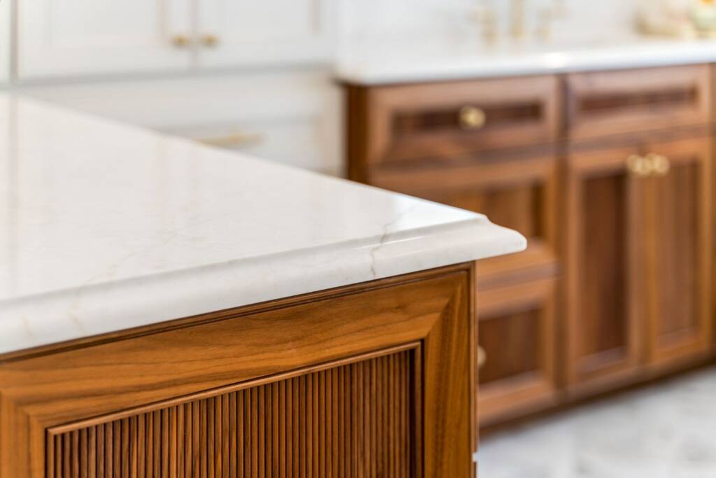 Primary bathroom wooden vanity with brass hardware