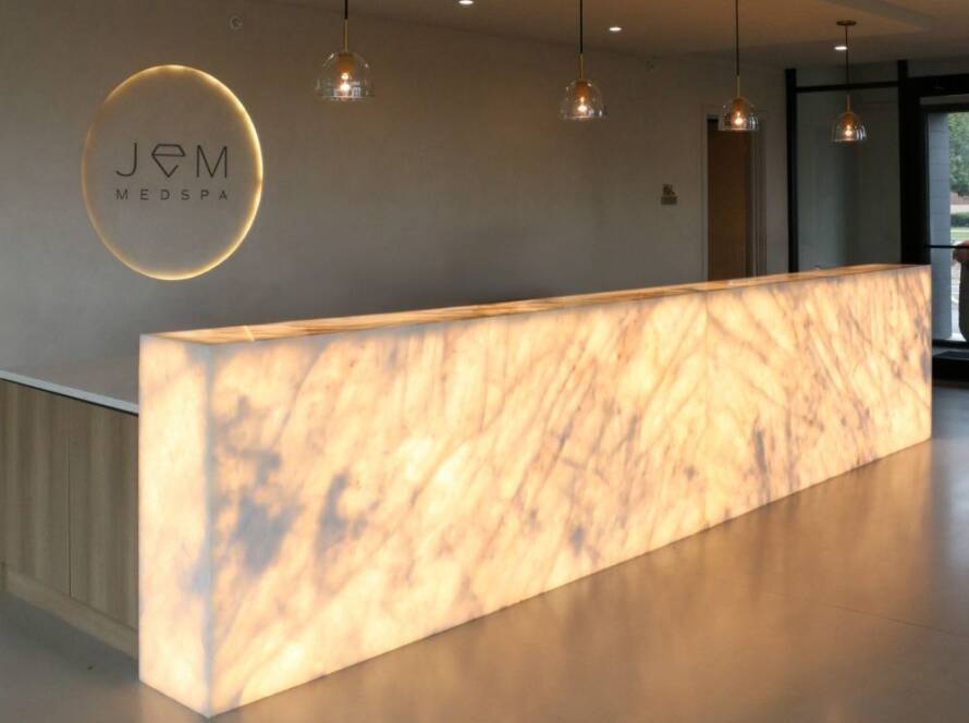 Backlit crystallo quartzite reception desk at jem spa