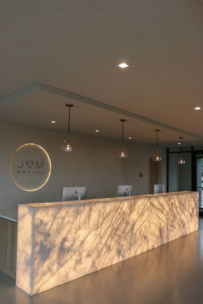 Backlit crystallo quartzite reception desk at jem spa